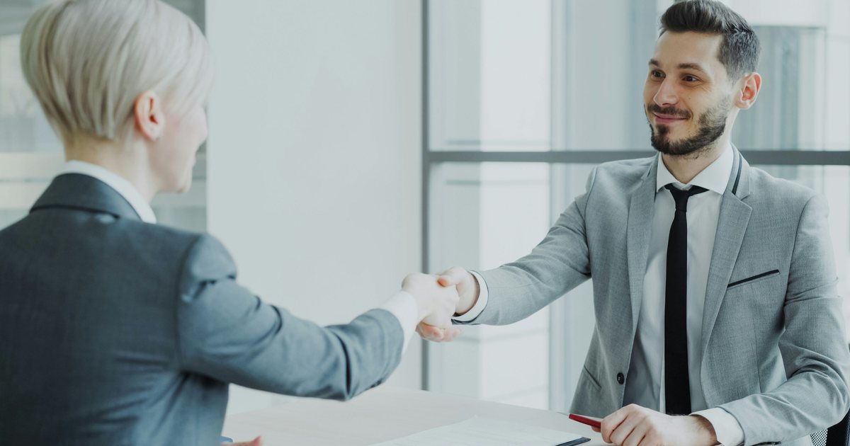 Dos profesionales dándose la mano tras cerrar un acuerdo