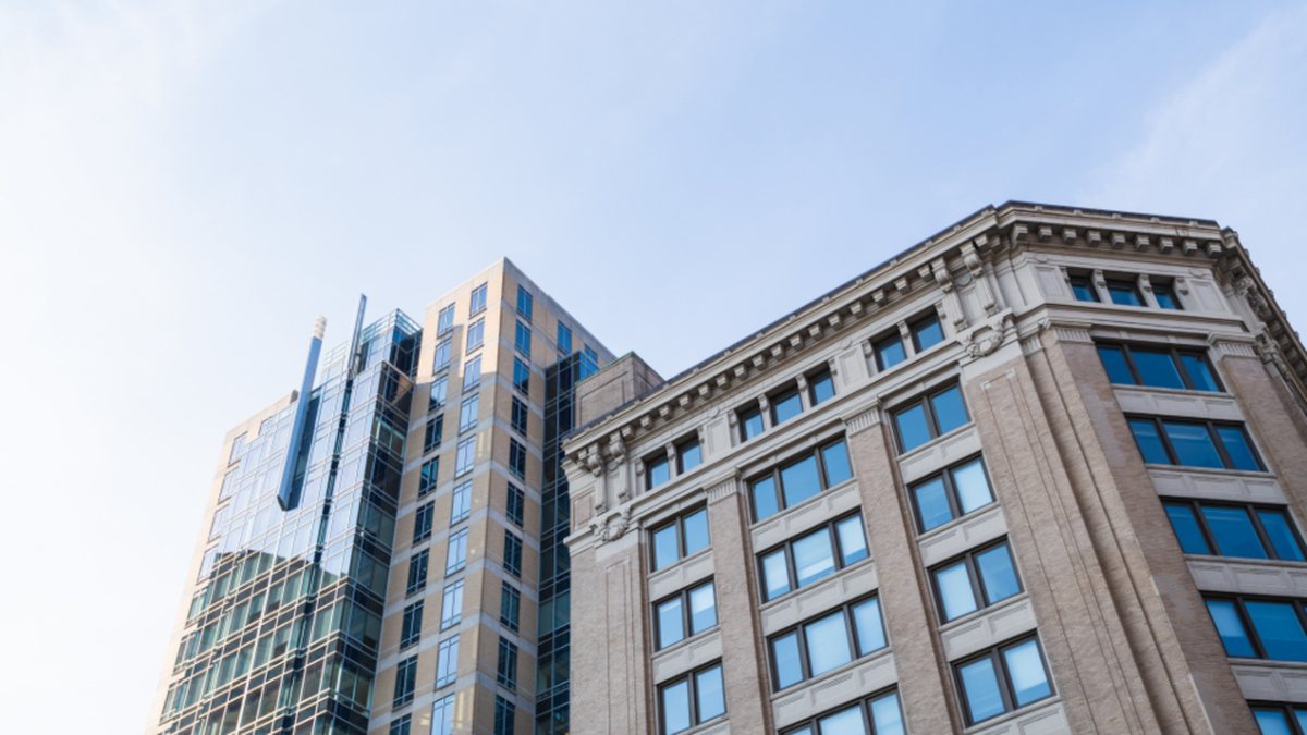 Fachadas de edificios de gran altura, con paneles de cristal y piedra, contra el cielo