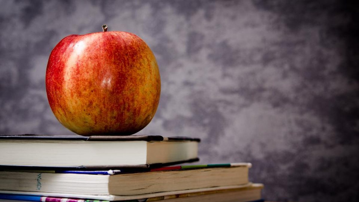 Manzana sobre una pila de libros de texto